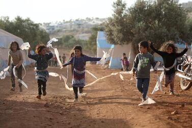 Syrian children play in a camp for internally displaced people near Kah, in the northern Idlib province near the border with Turkey in June 2019. Syria is no longer ranked the least peaceful country in the world, according to the annual World Peace Index. Aaref Watao / AFP