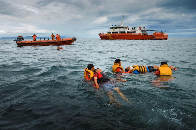 Indonesian search and rescue team members rescue two "victims" during operational drills in the waters off Banda Aceh. AFP