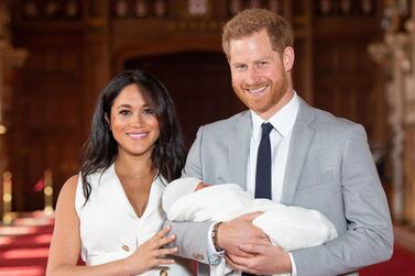 Britain's Prince Harry, Duke of Sussex, and his wife Meghan, Duchess of Sussex, pose for a photo with their newborn baby son, Archie Harrison Mountbatten-Windsor, in St George's Hall on May 8, 2019, two days after his birth. AFP 