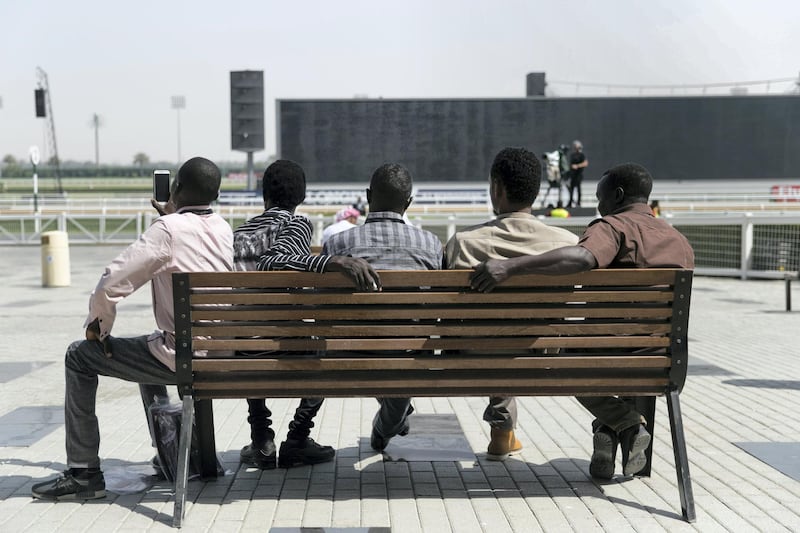 DUBAI, UNITED ARAB EMIRATES - MARCH 31, 2018. 

Five men sit on a bench at Dubai World Cup 2018.

(Photo by Reem Mohammed/The National)

Reporter: 
Section: NA