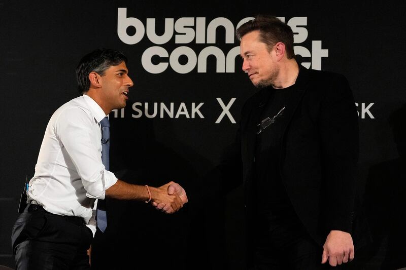Britain's Prime Minister Rishi Sunak, left, shakes hands with X chief executive Elon Musk following the UK Artificial Intelligence Safety Summit. AFP