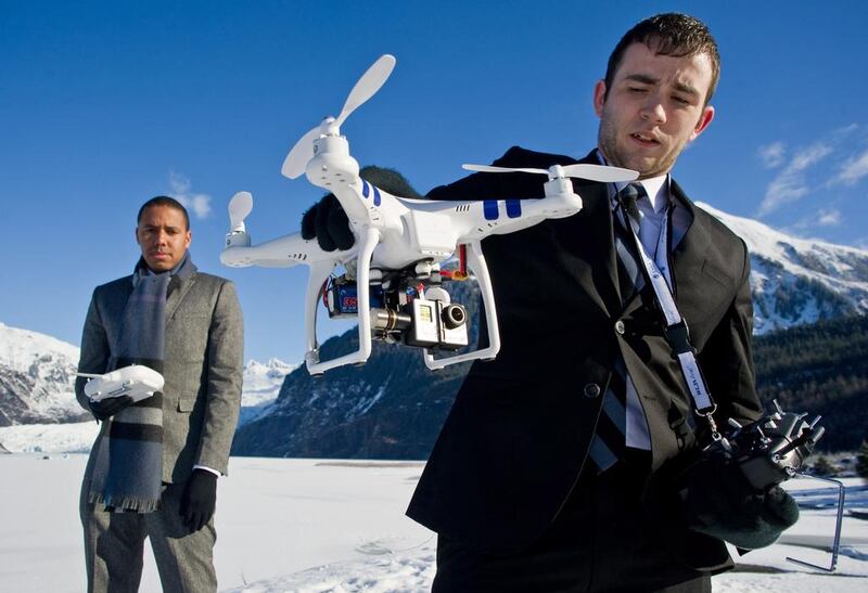 Chris Carson, right, and Lion El Aton of Firefight Films show the gimbaled GoPro video camera attached to the bottom of the DJI Phantom drone quadcopter at Mendenhall Lake in Juneau, Alaska on March 20, 2014. They have been using the unit to film the glacier and an ice cave this winter. Juneau Empire / Michael Penn / AP Photo