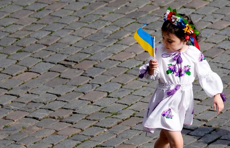 A young girl displays some patriotism during an event in central Brussels for Ukrainian Independence Day, which arrive six months to the day since Russia's invasion. AP