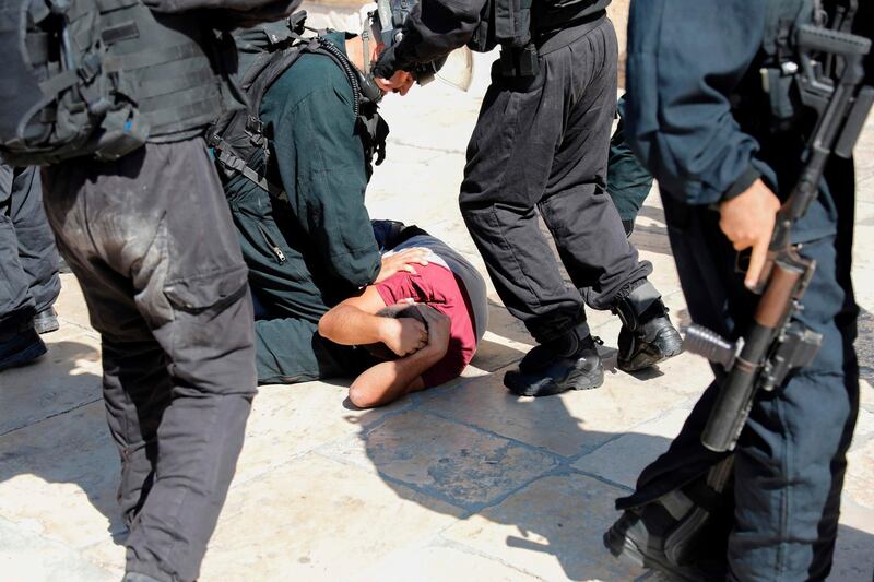 Israeli security forces detain a Palestinian at the Al Aqsa Mosque compound. AFP