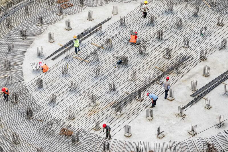 Employees working at the construction site of a grain storage project in Yancheng, in eastern China's Jiangsu province. AFP