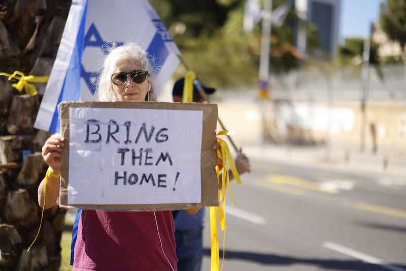 A woman holds a sign demanding the release of Israelis kidnapped by Hamas militants. Bloomberg