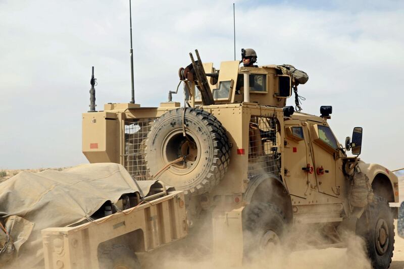 A military vehicle with the US-backed Syrian Democratic Forces (SDF) rides during an operation to expel Islamic State group (IS) jihadists from the Baghouz area in the eastern Syrian province of Deir Ezzor on February 13, 2019. Syrian fighters backed by artillery fire from a US-led coalition battled a fierce jihadist counteroffensive as they pushed to retake a last morsel of territory from the Islamic State group in an assault lasting days. More than four years after the extremists declared a "caliphate" across large parts of Syria and neighbouring Iraq, several offensives have whittled that down to a tiny scrap of land in eastern Syria. / AFP / Delil souleiman

