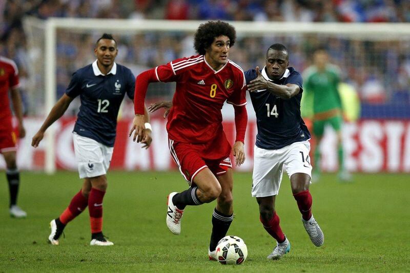 France’s Blaise Matuidi, right, challenges Belgium’s Marouane Fellaini, centre, during their international friendly match at the Stade de France in Saint-Denis, near Paris, France June 7, 2015. REUTERS/Benoit Tessier