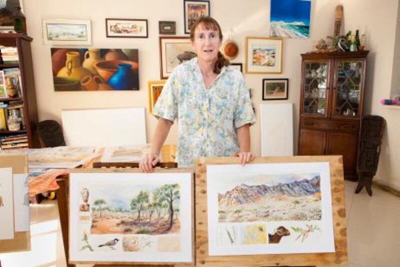 UAE - Ras Al Khaimah - Nov 04 - 2011: Beverly McKay pose for a portrait with her paintings at her home. She is a rak based artist and scientist who is documenting the disapearing landscapes of RAK through paintings and biology. ( Jaime Puebla - The National Newspaper )