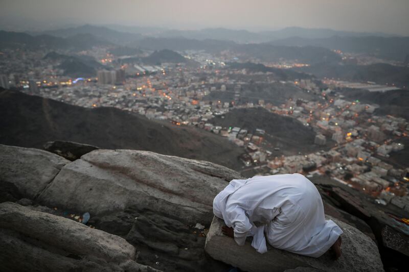 A Muslim worshipper prays on the top of Mount Al-Noor in Mecca, Saudi Arabia. Mast Irham / EPA