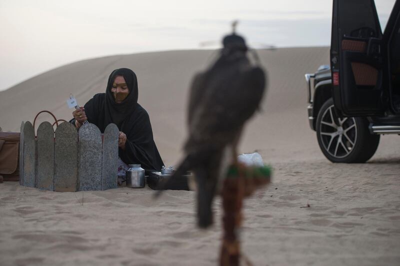 Food being prepared by Afrah Al Mansoori aunt of Ayesha after training session at the remote desert and the falcon rest in the perch at Abu Dhabi, UAE.

This is photograph reflect traditional way of cooking in the desert which reflect Bedouin life and right side sophisticated car rim shows modernized of Abu Dhabi but falcon travels in Emirati life, past ,present and future. Vidhyaa for The National