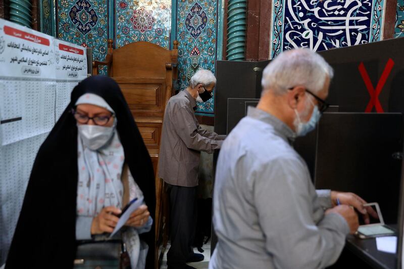 Voters fill out their ballot papers during the presidential elections at a polling station in Tehran, Iran. Reuters