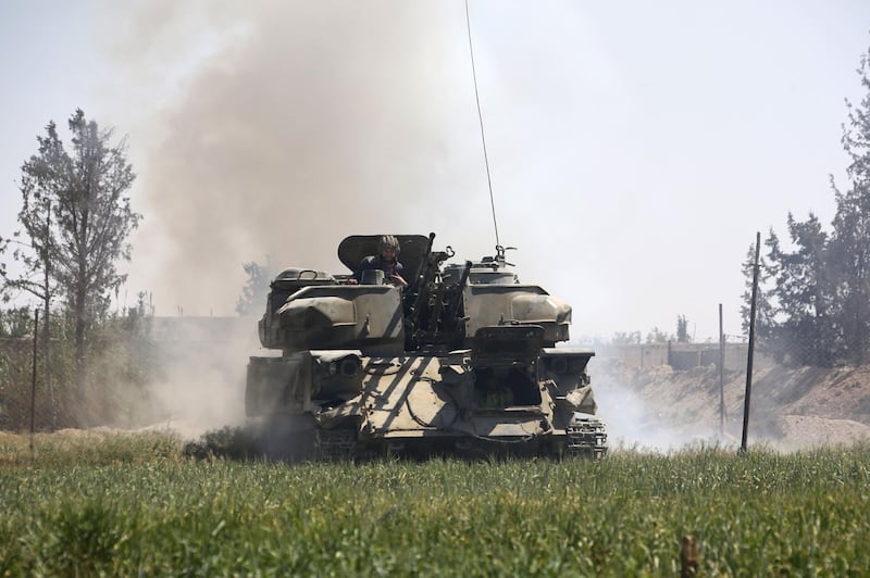 Pro-Syrian regime forces are seen as they advance towards the town of Douma, the last opposition holdout in Eastern Ghouta, on April 7, 2018, after regime troops resumed a military blitz to pressure rebels to withdraw.  AFP