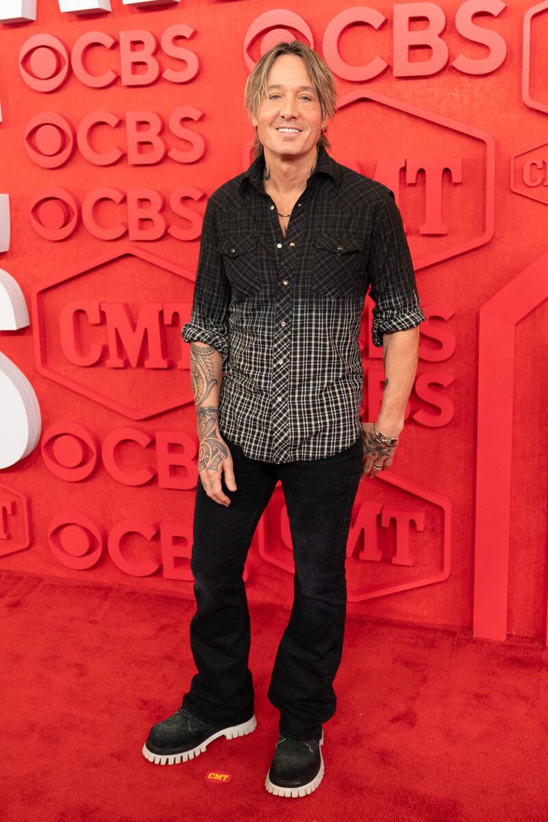 Keith Urban wore black jeans, black trainers and a black and grey button-down shirt. AFP 