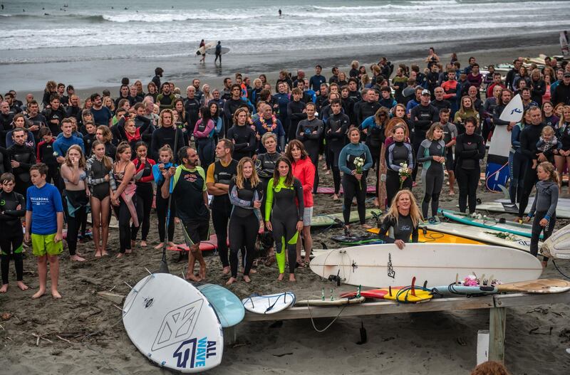 Surfers listen to a Karakia (Maori incantation and prayer) to remember victims of the Christchurch mosque attacks, on March 23, 2019 in Christchurch, New Zealand. Getty Images
