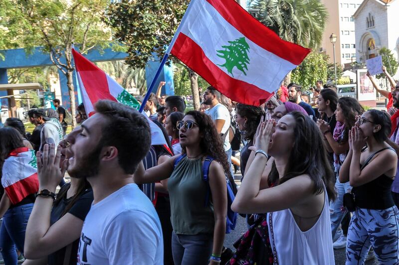 Lebanese students from various universities shout slogans during ongoing anti-government protests as they march from Lebanese University toward Riad Solh square in front the government palace in Beirut.  EPA