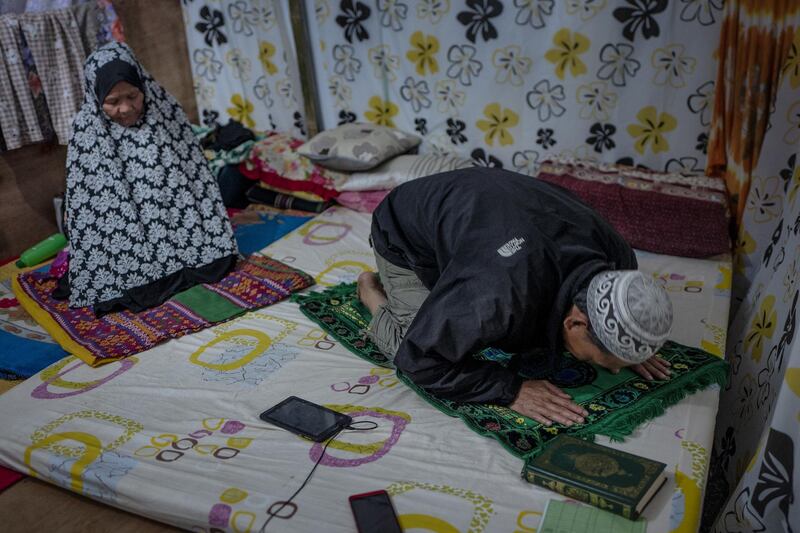 Saadudin Bangkula, 44, and Mamhaypa Manta Sungran Baubaton, 66, pray inside their shelter as the makeshift mosque for them was not finished in time for the start of Ramadan.