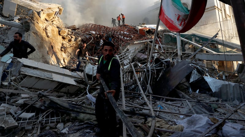 Rescue workers at the destroyed Iranian embassy compound in Damascus. AP