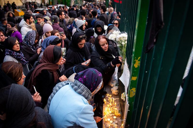 Demonstrators gather during a vigil for the victims of the Ukraine International Airlines flight that was unintentionally shot down by Iran, in Tehran, Iran, on Saturday, January 11.  Bloomberg