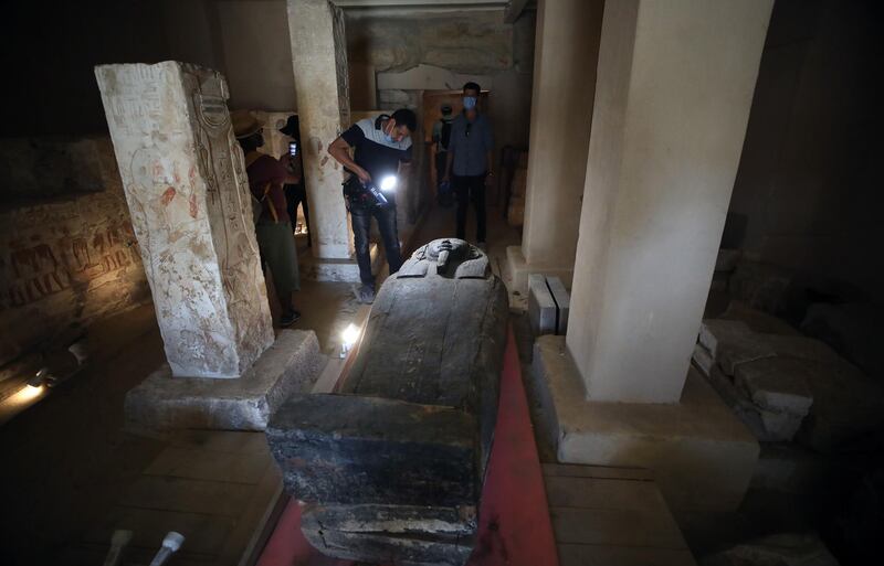 People inspect the sarcophagus on display after they were discovered at Saqqara Necropolis, Giza, Egypt.  An Egyptian archaeological mission uncovered a total of 59 intact and sealed coffins in three burial shafts dozen of meters deep in the Saqqara necropolis. EPA