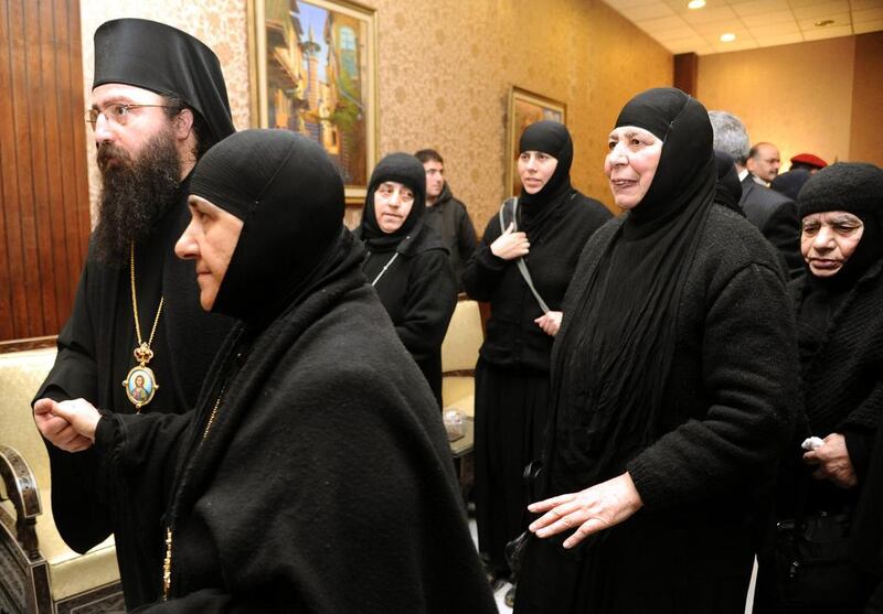 A group of nuns who were freed after being held by rebels greet church officials at the Syrian border town of Jdeidat Yabous on March. 10. AP/SANA