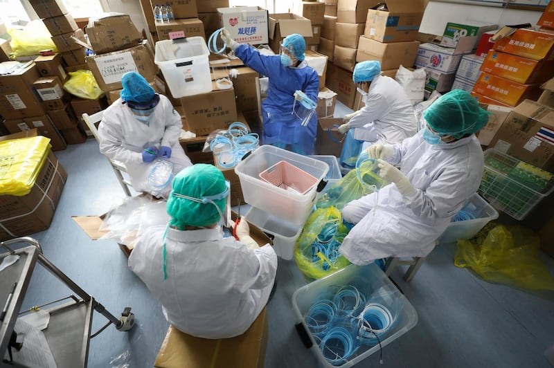 Nurses assemble plastic face shields at a hospital designated for the coronavirus patients in Wuhan in central China's Hubei province.  AP