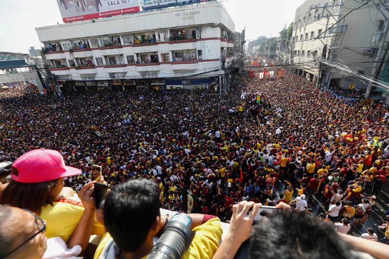 The Black Nazarene is taken on a procession as Catholic devotees flock around to mark its feast day in Manila, Philippines. EPA