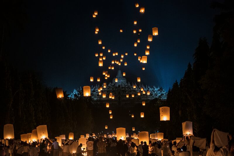 Buddhist devotees and tourists release lanterns into the air on Borobudur temple during celebrations for Vesak Day in Magelang, central Java, Indonesia.  Getty Images