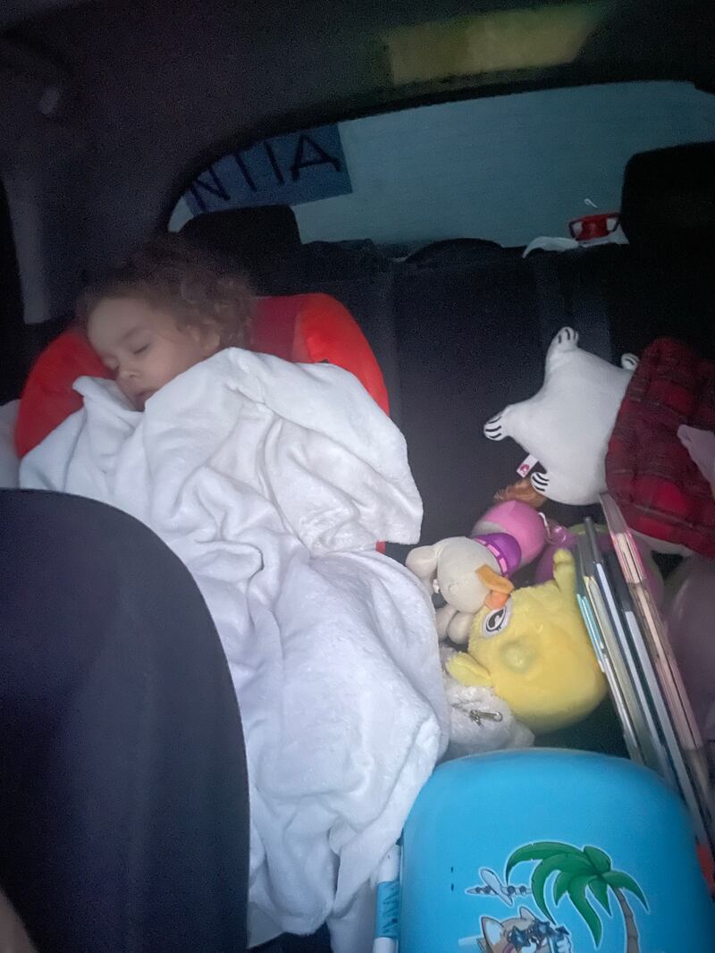 Mykhailyna gets some sleep during the journey by road from Odesa to Poland. Unicef has warned of the long-lasting impact on children’s physical and mental health of instability and fear when they leave their homes, family members, friends, toys and belongings. Photo: Alexandra Iliashenko