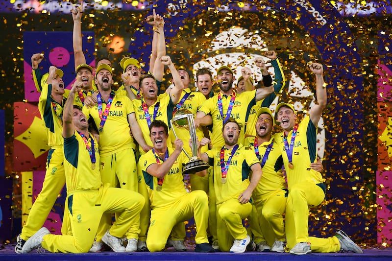 Australia celebrate with the Cricket World Cup trophy after their victory against India at Narendra Modi Stadium on November 19, 2023. Getty Images