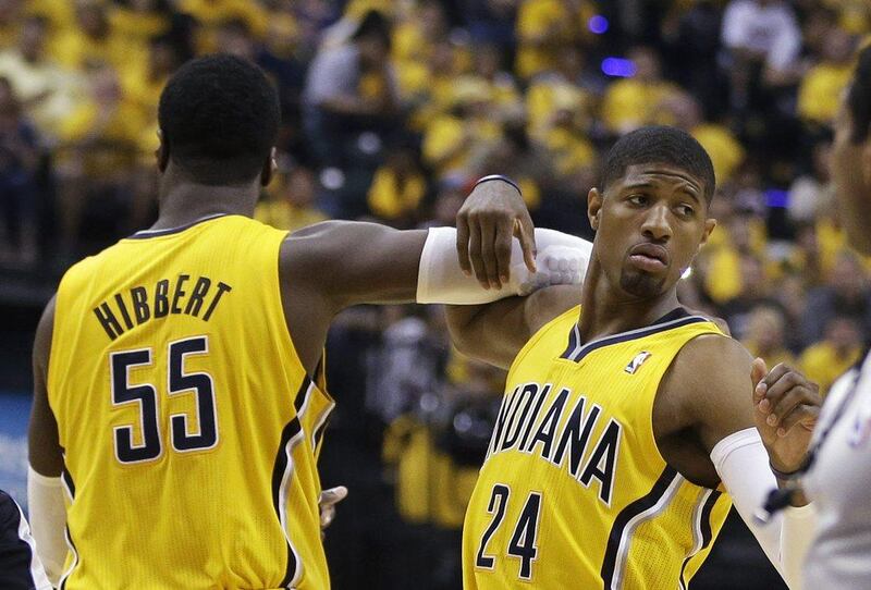 Roy Hibbert, right, and Paul George, left, of the Indiana Pacers celebrate during their win on Sunday night over the Miami Heat. Darron Cummings / AP / May 18, 2014