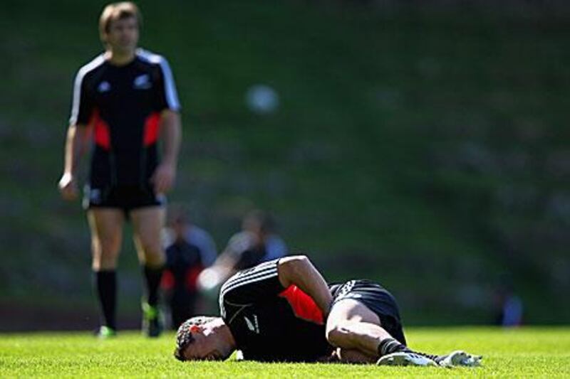 Dan Carter goes down injured at kicking practice yesterday. His injured groin forces the All Blacks fly-half out of the Rugby World Cup.