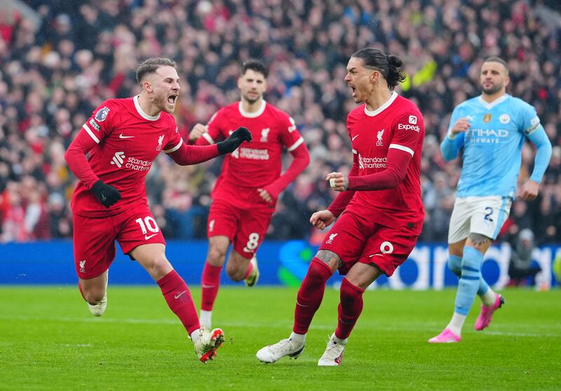 Liverpool's Alexis Mac Allister, left, celebrates after scoring a penalty to equalise against Manchester City in the Premier League game at Anfield on March 10, 2024. AP
