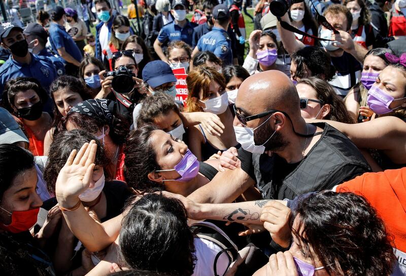 A plain-clothes police officer scuffles with a protester at a march in Istanbul against Turkey's abandonment of the Istanbul Convention. Reuters