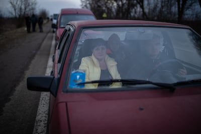Ludmilla waits in her car with her family in a traffic jam backed up towards the border crossing into Poland. Oliver Marsden for The National