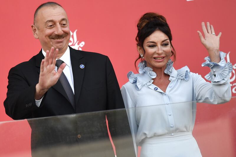 (FILES) This file photo taken on June 25, 2017 shows Azerbaijan's President Ilham Aliyev (L) and Azerbaijani First Lady and First Vice President Mehriban Aliyeva waving while standing on the podium after the Formula One Azerbaijan Grand Prix at the Baku City Circuit in Baku.
Azerbaijan's ruling elite ran a secret 2.5 billion euro ($2.9 billion) slush fund to pay off European politicians and launder money, according to an investigation by a group of European newspapers published on September 5, 2017. The fund operated for two years from 2012 to 2014 through bank accounts of four shell companies registered in Britain, according to the investigation by papers including The Guardian and France's Le Monde and published by the Organized Crime and Corruption Reporting Project. Nicknamed the "Azerbaijan Laundromat", the origin of the fund is unclear "but there is ample evidence of its connection to the family of President Ilham Aliyev", the report said.
 / AFP PHOTO / Andrej ISAKOVIC
