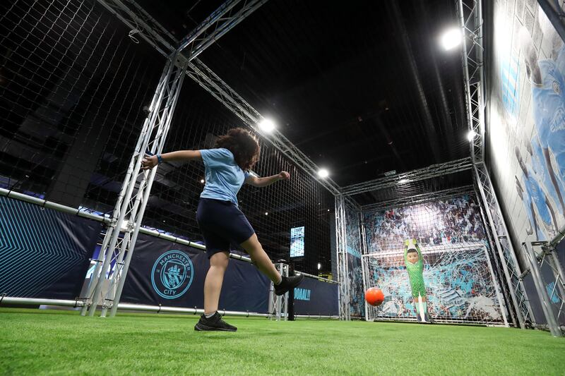 A young visitor takes part in the shooting challenge at the new attraction at Yas Mall.