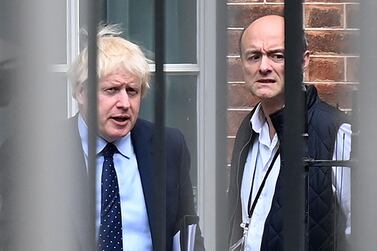 Boris Johnson and his then-special adviser Dominic Cummings leave from the rear of Downing Street in April 2021. AFP