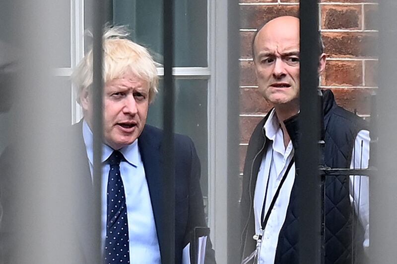 (FILES) In this file photo taken on April 26, 2021 (FILES) Britain's Prime Minister Boris Johnson (L) and his special advisor Dominic Cummings leave from the rear of Downing Street in central London, before heading to the Houses of Parliament. Ahead of a much-anticipated hearing into Britain's coronavirus response, former chief adviser Dominic Cummings, who is due to give give evidence to the House of Commons select committees on health and science on May 26, 2021, has accused Prime Minister Boris Johnson of lying about pursuing a strategy of herd immunity when the pandemic first hit. / AFP / DANIEL LEAL-OLIVAS
