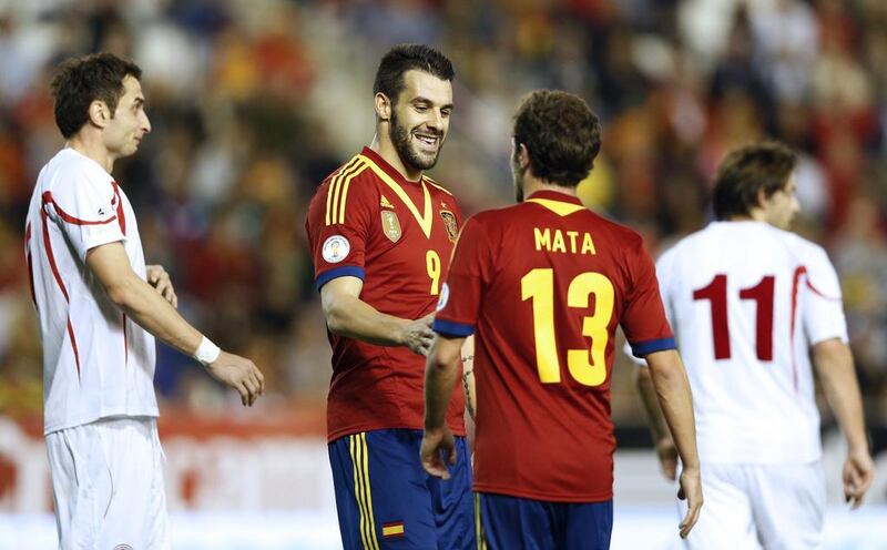 Spain's Negredo, second from left, chats with teammate Juan Mata during the World Cup 2014 qualifying football match against Georgia at the Carlos del Monte stadium in Albacete on October 15. Spain won 2-0. Jose Jordan / AFP

