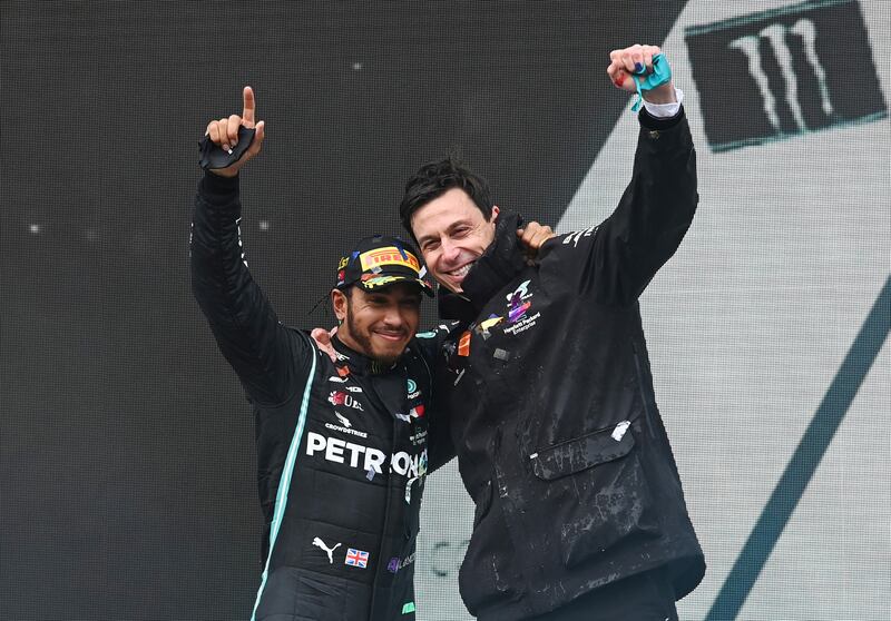 Hamilton celebrates on the podium with team principal Toto Wolff after winning the Turkish Grand Prix and the world championship on November 15, 2020. Reuters