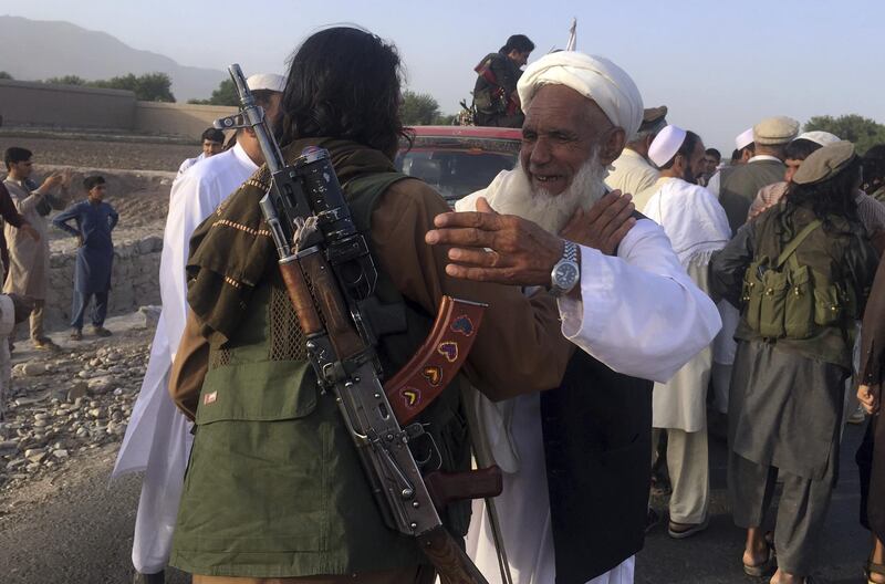 Taliban fighters gather with the residences in Surkhroad district of Nangarhar province, east of Kabul, Afghanistan, on June 16, 2018.  Rahmat Gal / AP Photo