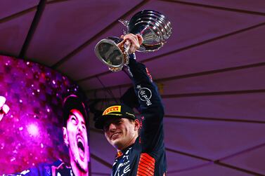 ABU DHABI, UNITED ARAB EMIRATES - NOVEMBER 26: Race winner Max Verstappen of the Netherlands and Oracle Red Bull Racing celebrates on the podium during the F1 Grand Prix of Abu Dhabi at Yas Marina Circuit on November 26, 2023 in Abu Dhabi, United Arab Emirates. (Photo by Mark Thompson / Getty Images)
