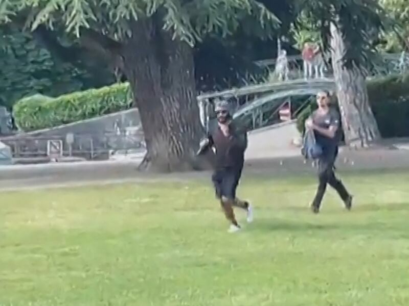 The man accused of the stabbing is seen running away, holding a knife. AFP