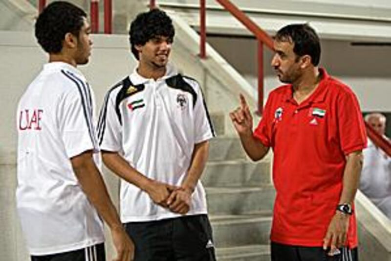 The UAE Under 17 coach Ali Ibrahim, right, speaks to his players Hassan Yousuf, left, and Mohammed Abdullah.