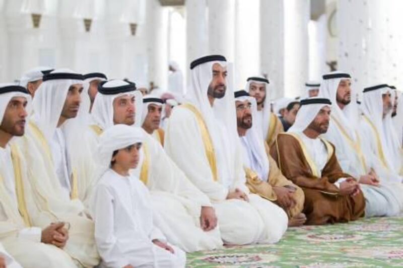 ABU DHABI, UNITED ARAB EMIRATES - August 19, 2012: (L-R excluding child)  HH Sheikh Nahyan Bin Zayed Al Nahyan, HH Sheikh Saeed bin Zayed Al Nahyan Chairman of Al Wahda Football Club, HH Sheikh Hazza bin Zayed Al Nahyan National Security Advisor for the United Arab Emirates and Vice Chairman of the Abu Dhabi Executive Council, HH General Sheikh Mohamed bin Zayed Al Nahyan Crown Prince of Abu Dhabi Deputy Supreme Commander of the UAE Armed Forces, HH Sheikh Saif bin Mohamed Al Nahyan, and HH Sheikh Suroor bin Mohamed Al Nahyan, unknown,  HH Sheikh Nahyan bin Mubarak Al Nahyan Minister of Higher Education and Scientific Research attend Shorook prayer at the Sheikh Zayed Grand Mosque on the first day of Eid Al Fitr. ( Ryan Carter / Crown Prince Court - Abu Dhabi )
