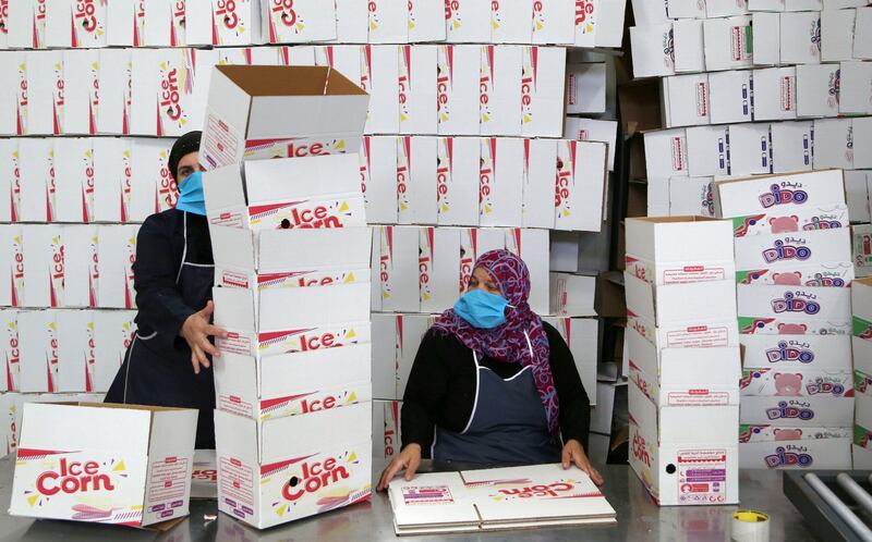 Workers arrange boxes to be filled with ice cream inside a factory in Damascus, Syria. Reuters