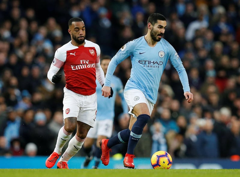 Soccer Football - Premier League - Manchester City v Arsenal - Etihad Stadium, Manchester, Britain - February 3, 2019  Manchester City's Ilkay Gundogan in action with Arsenal's Alexandre Lacazette   REUTERS/Andrew Yates    EDITORIAL USE ONLY. No use with unauthorized audio, video, data, fixture lists, club/league logos or "live" services. Online in-match use limited to 75 images, no video emulation. No use in betting, games or single club/league/player publications.  Please contact your account representative for further details.