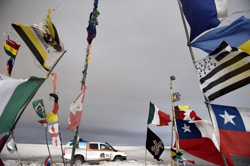 Dakar rally director Etienne Lavigne and staff members ride through Bolivia, near the Andes, at the Salar de Uyuni salt pan as they scout out locations for the 2015 Dakar Rally. Franck Fife / AFP / September 18, 2014