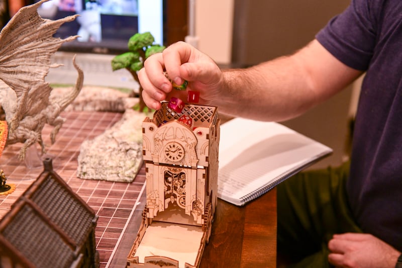 One of the players rolls dice during the game 'Curse of Strahd' while playing Dungeons & Dragons.